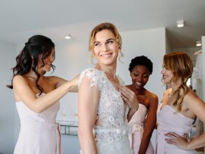 Bride and bridesmaid getting ready for wedding
